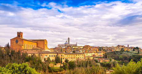 Fototapeta na wymiar Siena sunset panoramic skyline. San Domenico and Duomo cathedrals. Tuscany,
