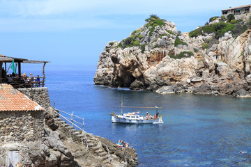 Europe, Spain, Balearic Islands, Mallorca. Cala Banyalbufar. Beachfront swimming. Harbor, Sunbathers.
