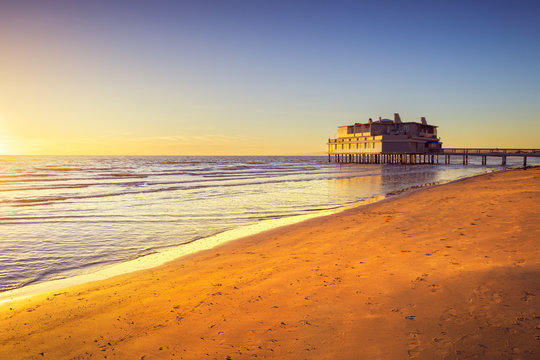 Pier and building on sea and beach. Follonica, Tuscany Italy