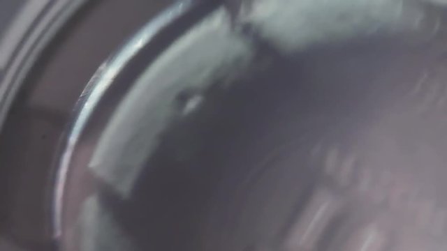 Clear water shaking in transparent glass, macro close up slow motion