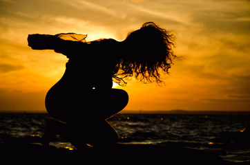 feminine silhouette on sunset background