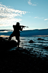 silhouette of a soldier aiming a rifle