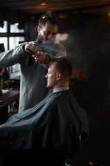 Barber cutting hair of customer