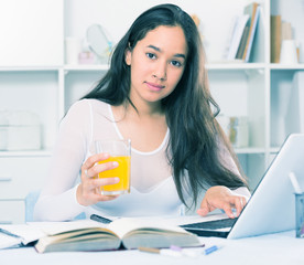 Portrait of young female sitting and writing
