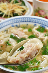 Wonton soup  in a spoon. Traditional asian food.