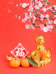 golden dog statue on red paper,translation of calligraphy: good Fortune for year of the dog,red stamp: year of the dog,2018 is year of the dog.