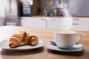 Croissant And Cup Of Coffee At Breakfast