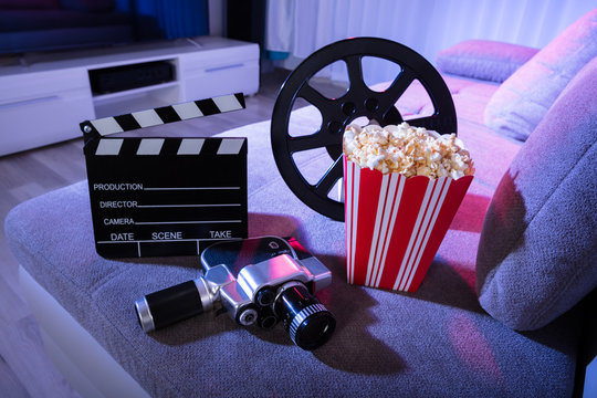 Movie Camera With Clapperboard And Popcorn