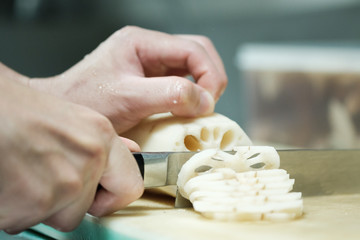 Chef training cut vegetable on cutting board with knife japan