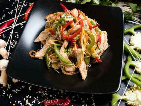 chicken vegetable salad on a plate. traditional asian cuisine food preparation craft