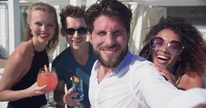 Funny friends in sunglasses taking selfies smiling feel happy on the party party beach couple summer man nature technology sun group beautiful posing outdoors friendship photo together vacation young