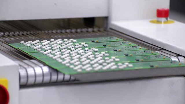 Electronic printed circuit board enters the air convection reflow oven.