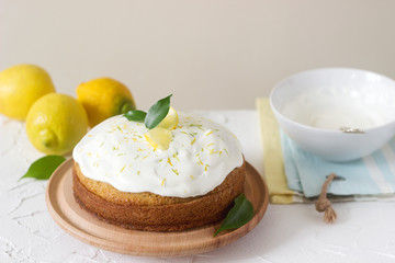 Obraz na płótnie Canvas Lemon cake with whipped cream on a light background.