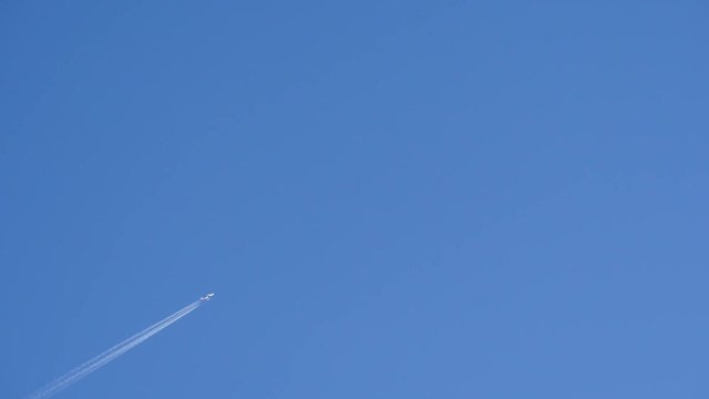 Tokyo, Japan-December 12, 2017: An airplane departed from Haneda airport flies drawing a white contrail on a blue winter sky in Tokyo.
