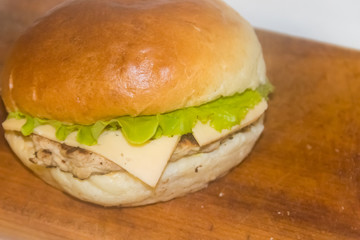 Fresh cheeseburger on wooden board