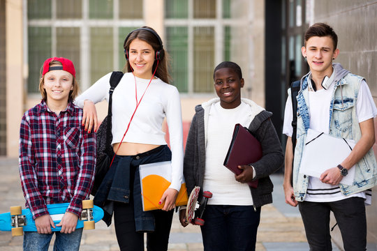 Group of teens posing outside school