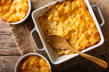  Delicious and hearty meal: casserole mac and cheese in a baking dish close-up. horizontal top view © FomaA
