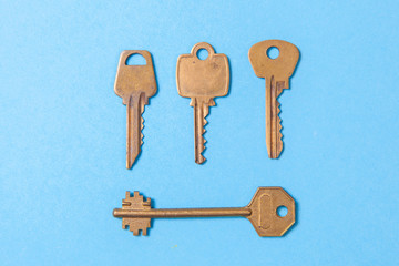 Old gold or copper keys on a blue background.