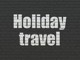 Tourism concept: Painted white text Holiday Travel on Black Brick wall background