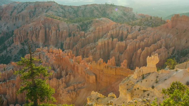 Rays of the sun illuminates orange cliffs. Spectacular view at the cliffs. Amazing mountain landscape. Nature video. Bryce Canyon National Park. Utah. USA. 4K, 3840*2160, high bit rate, UHD