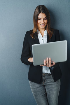 Attractive businesswoman using a handheld laptop