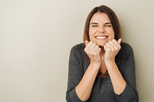 Beaming young woman screwing up her eyes