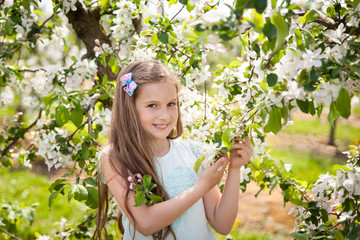 Beautiful young girl in spring garden