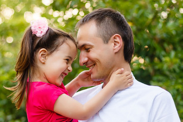 Fototapeta premium Portrait of little girl hugging her daddy