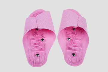 Pink spa slippers massage for health on a gray background