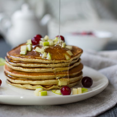 Pancakes with apple, berries and honey. Concept health breakfast.