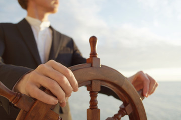 Captain. Hands on ship rudder. © Anton Sokolov
