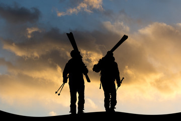 people skiers on mountain at sunset