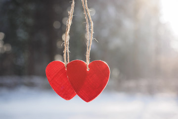 Two red hearts and winter snow scene background