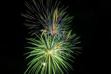 Fototapeta premium Brightly colorful fireworks a variety of colors in the sky at night