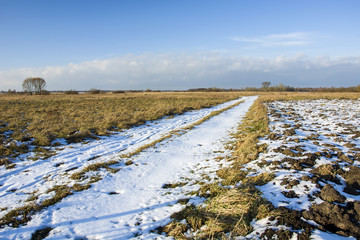 Long snow-covered country road