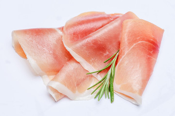 Italian prosciutto crudo or spanish jamon. Raw ham on white background.