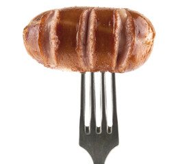 fried sausage on a metal fork isolated on a white background