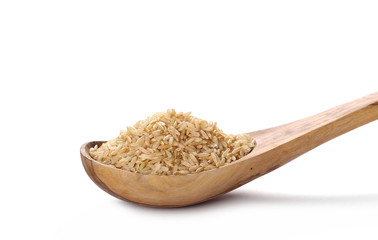 Integral, long grain brown rice pile in wooden spoon isolated on white background