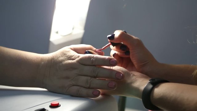 Manicour. Nail coating with gel-varnish. ultraviolet lamp for nails.