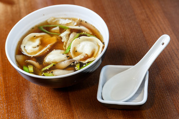Asian dumplings served and prepared as a soup