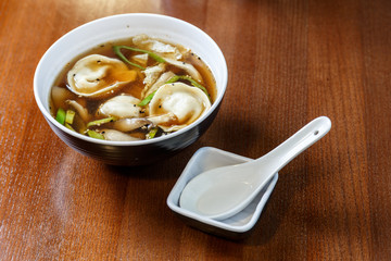Asian dumplings served and prepared as a soup