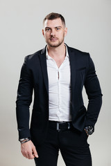 Portrait of a successful businessman in a suit, business coach / consulting. Studio shot with a flipchart on a white background.