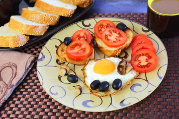 Food, breakfast. In the morning on the table prepared eggs, toast, tomatoes, pickled mushrooms, cocoa, baguette and black olives.