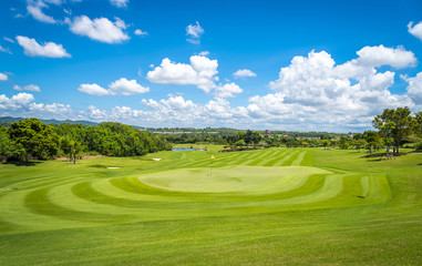 Green grass and trees at golf course with blue cloud sky background  © APchanel