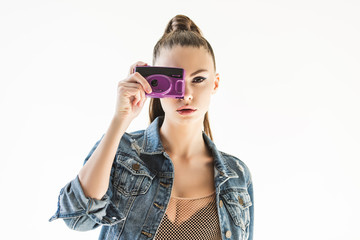 Naklejka premium girl posing in denim clothes with retro camera, isolated on white