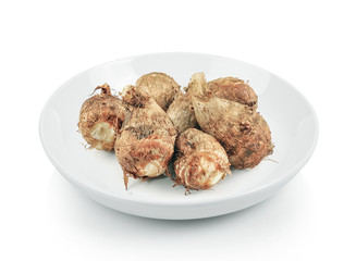 Taro root in plate on white background