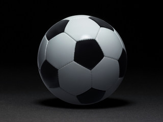 Fototapeta na wymiar Soccer ball on black background