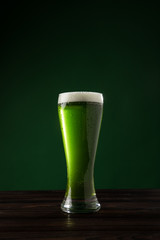 glass of green beer on table, st patricks day concept