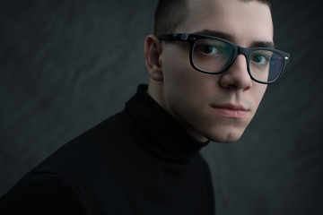 Portrait of young beautiful man in glasses