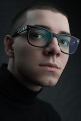 Fototapeta na wymiar Portrait of young beautiful man in glasses